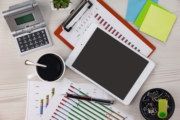 Annual financial reports and statements laid out on a structured workspace